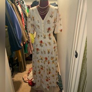 White floral layered dress with lace detailing.